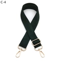 Detailed view of dark green diamond pattern shoulder strap with gold metal hardware - Gold Buckle / Green