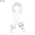 Detail of adjustable white woven bag strap with golden metal hardware and embroidery - White