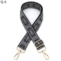 Close-up of ethnic embroidered guitar strap with gold lobster clasps and floral pattern - Black and Gray