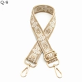 Detail of adjustable ethnic style bag strap with floral embroidery and gold metal hooks - Khaki and White
