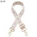 Close-up of ethnic style embroidered floral bag strap with light gold metal hardware - White Nude Pink