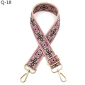 Close-up of pink ethnic style woven bag strap with golden metal hooks and floral patterns - Khaki Rose Black