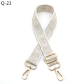 Close-up of bohemian floral guitar style replacement bag strap with golden metal clasps - Off White