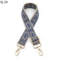 Detail of adjustable woven bag strap with blue ethnic patterns and gold lobster clasps - Blue