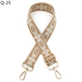 Close-up of bohemian style embroidered bag strap with floral pattern and gold metal clips - Brown and White