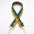 Detail of adjustable wide shoulder strap with green wave pattern and gold metal hooks - Yellow-Green