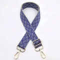 Detail of blue and beige woven bag strap with adjustable gold lobster clasps - Silver Clasp / Royal Blue (No. 2) / [product Attributes] This Appears To Be A Widened Woven Bag Shoulder Strap. The Main Body Uses A Geometric Woven Pattern In Blue And Beige Giving It A Substantial Feel. Both Ends Of The Shoulder Strap Feature Light Gold Metal Lobster Buckles And A Metal Adjustment Buckle Allowing For Length Adjustment And Making It Suitable For Various Shoulder Bags Or Crossbody Bags. [visual Presentation] The Image Uses A Pure White Background Taken From A Vertical Top-down Angle To Showcase The Complete Shape Of The Shoulder Strap And Hardware Details. Image Quality Is [high] With Clear Focus And Even Light And Shadow Distribution. Aesthetics Are [medium] With An Overall Score Of [7.2]. This Is A Standard E-commerce White Background Display Image But The Presentation Is Rather Bland And Lacks Visual Impact. [text Content] The "to_remove" Group Contains The Chinese Serial Number "2" In The Upper Left Corner Which Is Unnecessary Information Added Later And Should Be Removed. [logistics Tags] None [infringement Risk] Product Infringement: None Probability [0.0]. Background Infringement: None. [product Parameters] The Image Does Not Display Specific Dimensions But It Appears To Be A Wide Shoulder Strap.