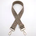Detail of adjustable woven bag strap with beige geometric pattern and gold buckles - Silver Clasp / Dark Khaki (No. 13) / [product Attributes] This Product Is An Adjustable Bag Shoulder Strap Visually Made Of Thickened Fabric With A Beige Geometric Woven Texture. It Features Gold-plated Metal Spring Buckles At Both Ends And An Adjustable Square Buckle Allowing For Interchangeable Use With Various Crossbody Or Shoulder Bags. [visual Presentation] The Image Uses A Top-down Flat Composition With A Pure White Background And Soft Lighting. Image Quality Is High With Rich Details Clearly Showcasing The Fabric Texture And Metallic Sheen. Aesthetics Are Moderate With An Overall Score Of 7.5. The Presentation Is Conventional And Lacks A Sense Of Atmosphere. [text Content] The To_remove Team Identified The Chinese Number "13" In The Upper Left Corner Which Is Post-added Text And Needs To Be Removed During Processing. [logistics Labels] None [infringement Risk] The Product Design Uses A Generic Geometric Pattern; No Brand Logo Or Copyrighted Ip Elements Were Found. Infringement Probability Is 0.1%. [product Parameters] Pattern: Geometric Woven; Material: Metal (gold-yellow); Function: Adjustable Length.