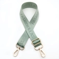 Detail of adjustable nylon bag strap in sage green with golden lobster clasps - Matcha Green