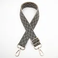Adjustable woven nylon bag strap with black and white checkerboard pattern and gold clips - Silver Clasp / Beige and Black (No. 21) / [product Attributes] This Product Is A [replaceable Shoulder Strap For A Bag] Made Of [nylon Woven Material] Featuring A Classic [black And White Geometric Checkered Pattern]. The Shoulder Strap Has [gold-plated Metal Rotating Hooks] At Both Ends And An [adjustable Sliding Buckle]. It Appears To Be A Universal Wide Shoulder Strap Suitable For Crossbody Bags Or Shoulder Bags. [visual Presentation] The Image Uses A [centered Symmetrical X-shaped Layout On A White Background] Fully Showcasing The Overall Shape Of The Shoulder Strap And Hardware Details. Image Quality Is [medium] With Good Clarity But A Somewhat Monotonous Background. Aesthetics Are [medium] With An Overall Score Of [7.2]. The Lighting Is Flat And The Overall Visual Presentation Leans Towards A Basic White Background Image. [text Content] To_remove: The "21" In The Upper Left Corner Is The Chinese Product Number Information; It Is Recommended To Remove It During Post-processing. [logistics Tags] None [infringement Risk] Product Infringement: None; Background Infringement: None. Infringement Probability: [0.0]. [product Parameters] Woven Material Black And White Color Scheme Gold Hardware Adjustable Length Design.