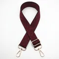 Detail of adjustable woven shoulder strap in burgundy and black with gold metal hardware - Silver Clasp / Black and Wine Red (No. 24) / [product Attributes] Visually This Appears To Be A Bag With A Widened Shoulder Strap Featuring A Burgundy And Black Geometric Diagonal Pattern With A Woven Texture. It Is Equipped With A Gold Metal Adjustment Buckle And Spring Hook Giving It An Overall Retro And Fashionable Style. [visual Presentation] The Image Was Taken Against A Pure White Background With An X-shaped Crossover Composition And A Centered Layout. Image Quality Is [high] With Accurate Exposure And Clear Focus. Aesthetics Are [medium] With An Overall Score Of [7.2]. The Presentation Style Leans Towards A Factory Direct Style Lacking A Sense Of Everyday Life Or Brand Identity. [text Content] To_remove: The Floating Layer Text "24" In The Upper Left Corner Is Internal Product Number Information And Should Be Removed. [logistics Tags] None. [infringement Risk] Product Infringement: None Probability [0.0]. Background Infringement: None. [product Parameters] No Parameters Are Marked But Gold Hardware Is Included.