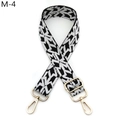 Detail of adjustable woven bag strap featuring black and white chevron patterns and gold buckles - M-4 Black and White