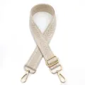 Detail of beige woven bag strap with herringbone pattern and gold rotating metal hooks - Beige