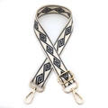 Detail of adjustable wide shoulder strap with navy geometric patterns and gold lobster clasps - Gold Buckle / Off White