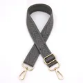 Detail of adjustable gray herringbone woven shoulder strap with gold metal swivel clasps - Gray