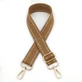 Close-up of brown herringbone woven strap with adjustable gold metal buckles on white background - Silver Clasp / Camel