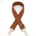 Detail view of brown herringbone woven strap with shiny gold lobster clasps and metal buckle - Tan