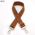 Close-up of adjustable brown geometric jacquard purse strap with gold metal hooks - Brown (W33)