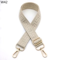 Detail of adjustable beige woven strap with golden metal hooks and jacquard pattern - Beige (W42)