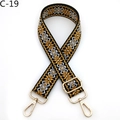 Detail view of ethnic embroidery pattern on adjustable crossbody bag strap with gold hardware - C-19 Black Yellow
