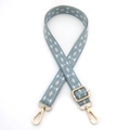 Detail of adjustable blue and white geometric diamond pattern woven shoulder strap with gold hooks - Teal