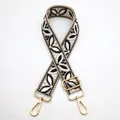 Close-up of adjustable ethnic jacquard bag strap with floral embroidery and gold metal clips - Style 34 Beige Black