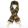 Close-up of ethnic embroidered bag strap with floral patterns and gold metal buckles - No. 4 Black Red Yellow Floral / Silver Clasp