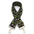 Close-up of ethnic jacquard bag strap with green floral embroidery and gold metal hooks - No. 6 Black Green Floral / Silver Clasp