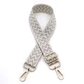 Detail of 3.8cm wide adjustable strap with silver chevron pattern and gold metal buckles - Silver Silk With White Edge