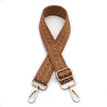 Detail of 3.8cm wide adjustable bag strap with brown chevron pattern and gold hardware - Brown