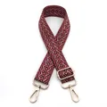 Close-up of 3.8cm wide adjustable bag strap with red chevron weave and gold metal hardware - Burgundy