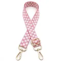 Close-up of pink and white checkered bag strap with adjustable gold lobster clasps - Pink