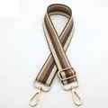 Detail of adjustable bag strap featuring beige and brown stripes with gold metal hooks - No. 9 Khaki Nude Pink Striped