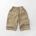 Detail of khaki kids cargo shorts featuring elastic waist and large pleated side pockets - Khaki / 80cm
