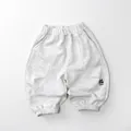 Close-up of light grey kids sweatpants with elastic waist and Look letter printing - Light Grey / 80cm