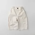 Detail of off-white kids wide-leg pants featuring elastic waist and black button detail - 80cm / Off White
