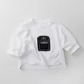 Detail of white cotton long-sleeve kids T-shirt with black graphic print and side slit - 80cm / White