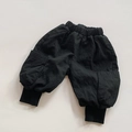 Detail of children's black cargo pants showing elastic waist and large side pockets - 80cm / Black