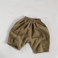Detailed texture of olive green cotton linen kids shorts with elastic waist and stitching - 80 / Khaki