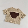 Dettaglio maglietta bimbi in cotone con toppa a forma di orsetto su tessuto beige - 80cm / Albicocca Beige