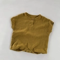 Close-up of mustard green double gauze cotton baby romper with wooden button detail - Yellow / 80cm