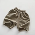 Detail of olive green kids cotton shorts with elastic waistband and raw-cut hem finish - 80cm / Matcha Green