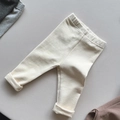 Detailed view of soft brushed cotton fabric and elastic waistband on beige baby leggings - 80cm / Off White