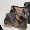 Detailed view of reversible quilted toddler vest with polka dot print and button closure - 80cm / Brown