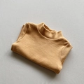 Detail of ginger yellow kids turtleneck shirt showing soft textured knit fabric texture - Yellow / 80cm