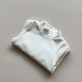 Detail of neatly folded off-white kids mock neck thermal top with premium knit texture - White / 80cm