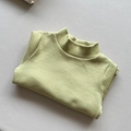 Detailed close-up of the soft olive green ribbed texture and turtleneck of this kids top - 80cm / Fruit Green