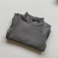Close-up of soft brushed dark grey mock neck knit sweater for kids neatly folded - Dark Gray