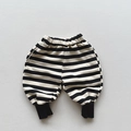 Detailed view of elastic waistband and ribbed cuffs on black and white striped kids joggers - 80cm / Black Stripe