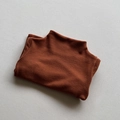 Detail of neatly folded brown turtleneck thermal top with soft brushed velvet texture - Brown & Yellow / 80cm